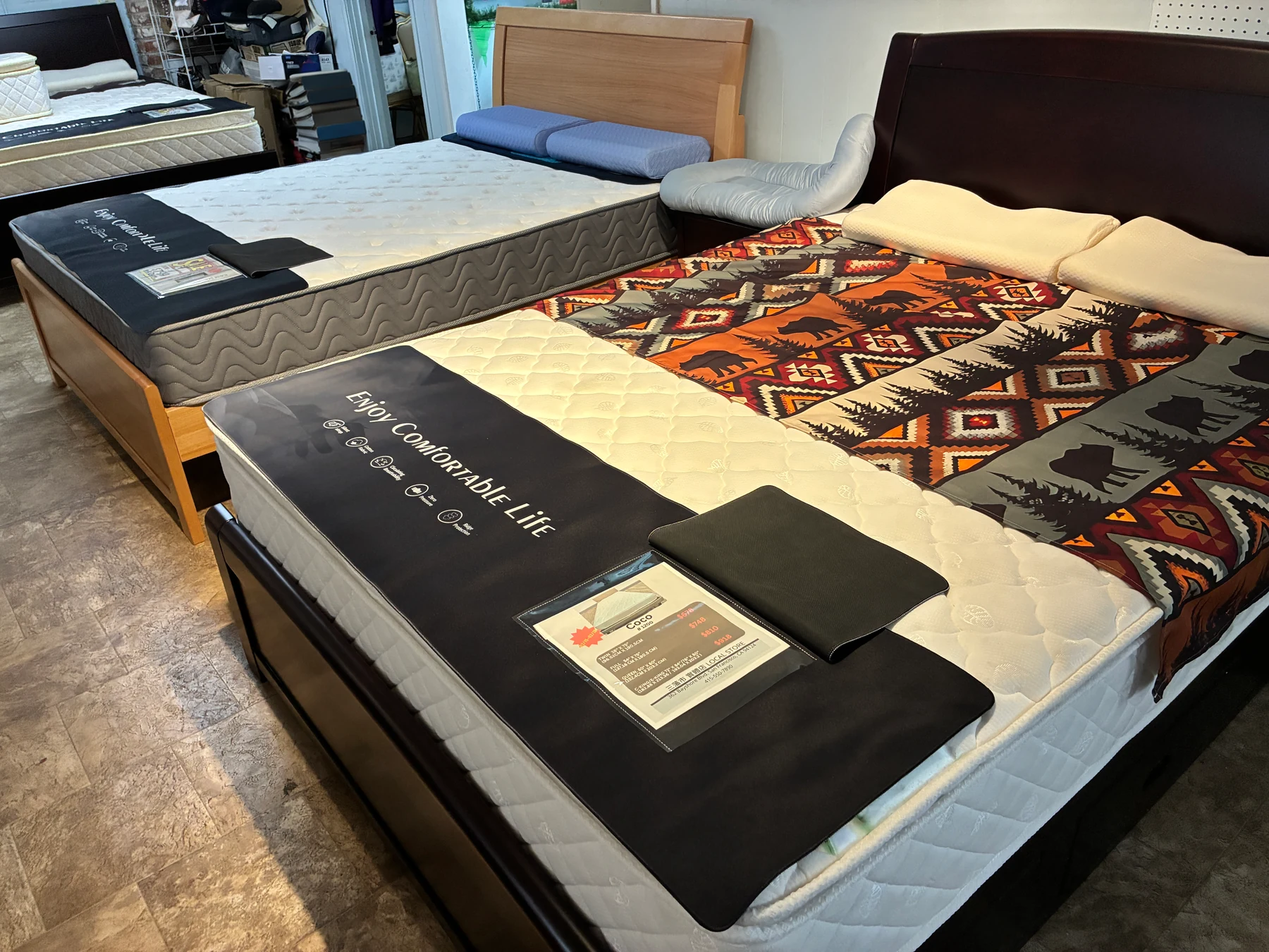 White quilted and gray wave-quilted mattresses displayed together in our Oakland showroom